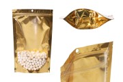 Doy Pack tipi çantalar 180x50x280 mm  alüminyum arka yüzü altın sarısı, önü şeffaf fermuarlı ve ısıl yapıştırma ile kapatma özelliği - 100 adet