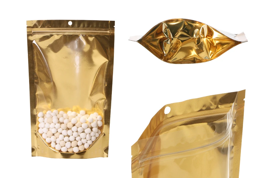 Алуминиеви торбички Doy Pack 180x50x280 мм със златиста задна част, прозрачна предна част с цип и възможност за термозапечатване - 100 бр. Алуминиеви торбички Doy Pack 180x50x280 мм със златиста задна част, прозрачна предна част с цип и възможност за термозапечатване - 100 бр.