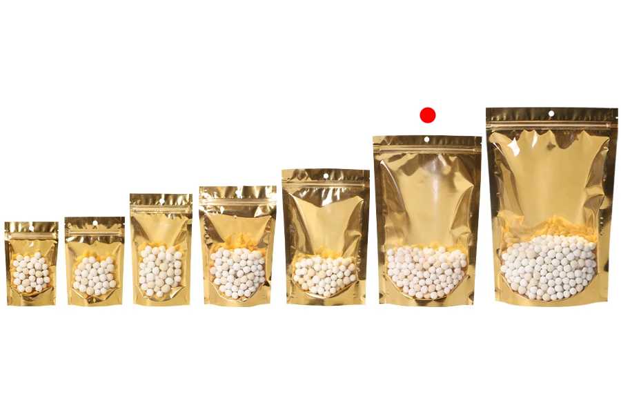 Алуминиеви торбички Doy Pack 180x50x280 мм със златиста задна част, прозрачна предна част с цип и възможност за термозапечатване - 100 бр. Алуминиеви торбички Doy Pack 180x50x280 мм със златиста задна част, прозрачна предна част с цип и възможност за термозапечатване - 100 бр.