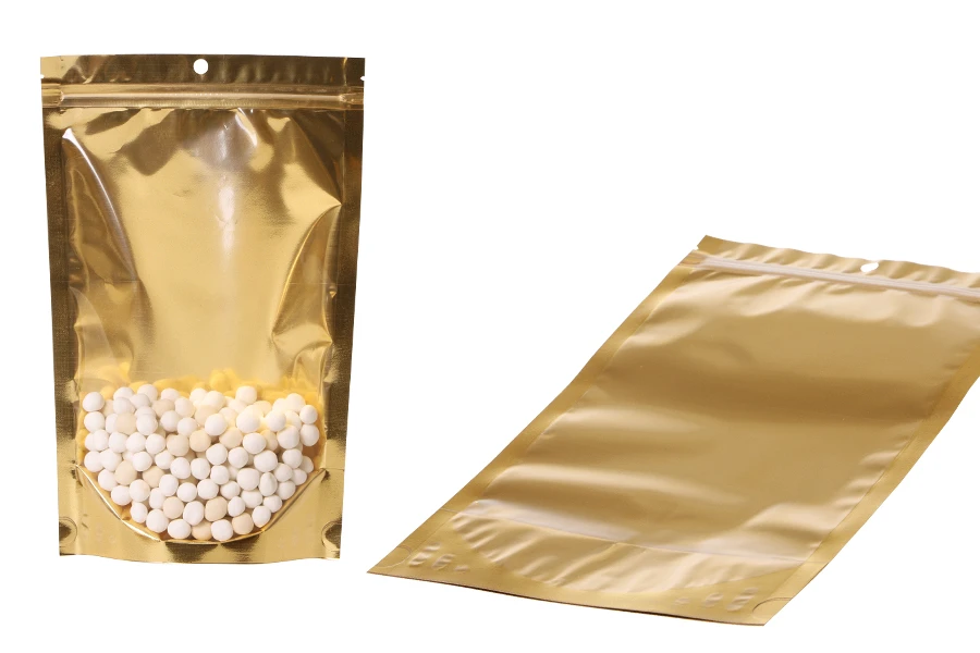 Алуминиеви торбички Doy Pack 180x50x280 мм със златиста задна част, прозрачна предна част с цип и възможност за термозапечатване - 100 бр. Алуминиеви торбички Doy Pack 180x50x280 мм със златиста задна част, прозрачна предна част с цип и възможност за термозапечатване - 100 бр.