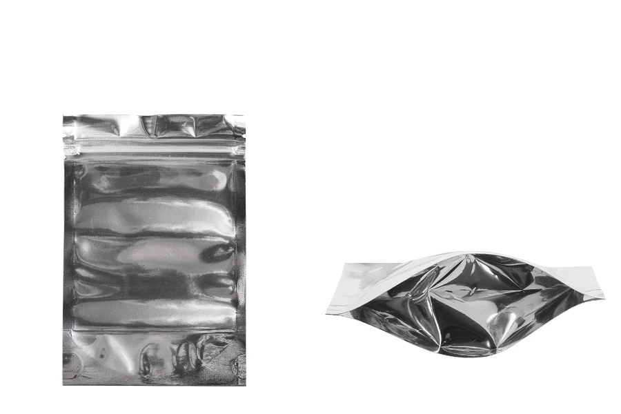 Опаковка тип Doy Pack с размери 100x30x150 mm с алуминиева задна част и прозрачна предна част с цип затваряне - 100 бр. Опаковка тип Doy Pack с размери 100x30x150 mm с алуминиева задна част и прозрачна предна част с цип затваряне - 100 бр.