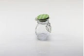 Стъклен буркан 100 мл с размери 84,5x53,5 mm с херметическо затваряне - пакет 12 броя с различни цветове капачки Стъклен буркан 100 мл с размери 84,5x53,5 mm с херметическо затваряне - пакет 12 броя с различни цветове капачки